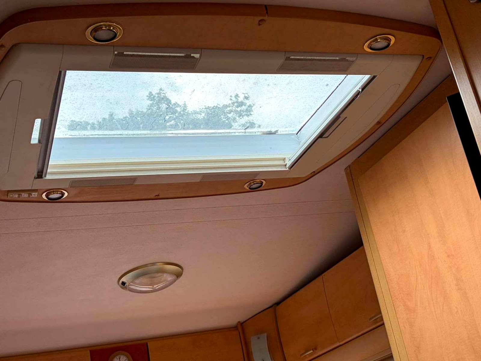 Clean used caravan interior showing lounge seating, washroom and kitchen fittings