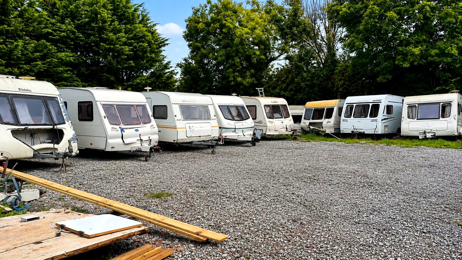 Row of caravans lined up at the yard waiting to be broken for parts