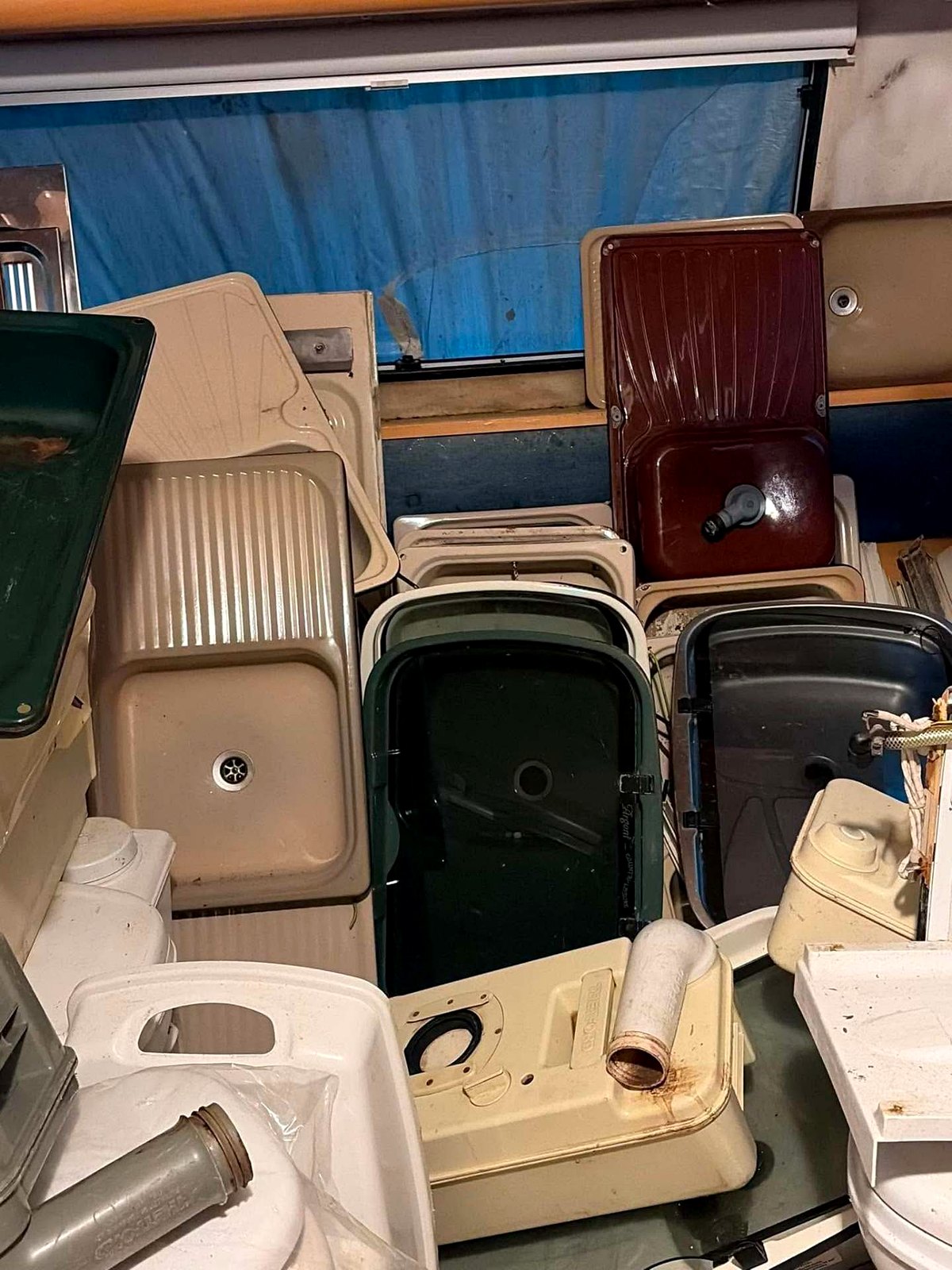 Caravan sinks, basins and drainers stacked by type in the store